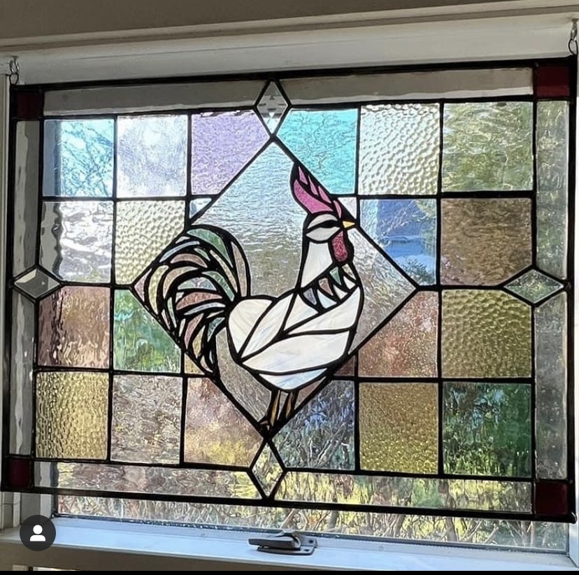 a stained-glass window of a chicken