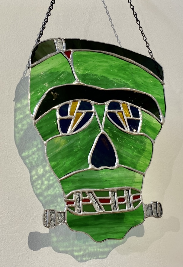 a green stained-glass Frankenstein's monster head